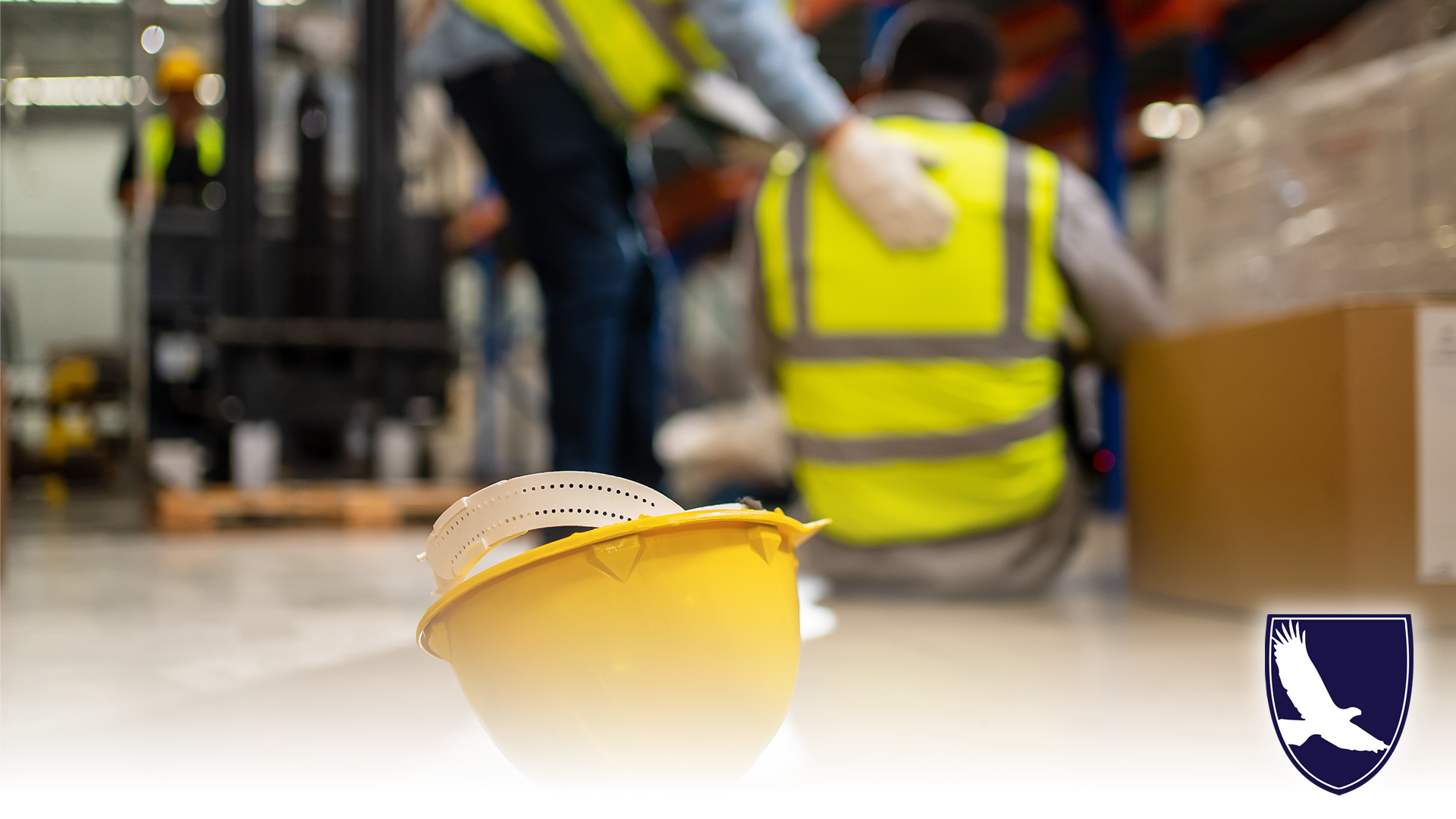 Worker injured on job, hard-hat on ground